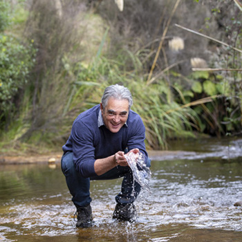 Tuatahi director washing hands in stream